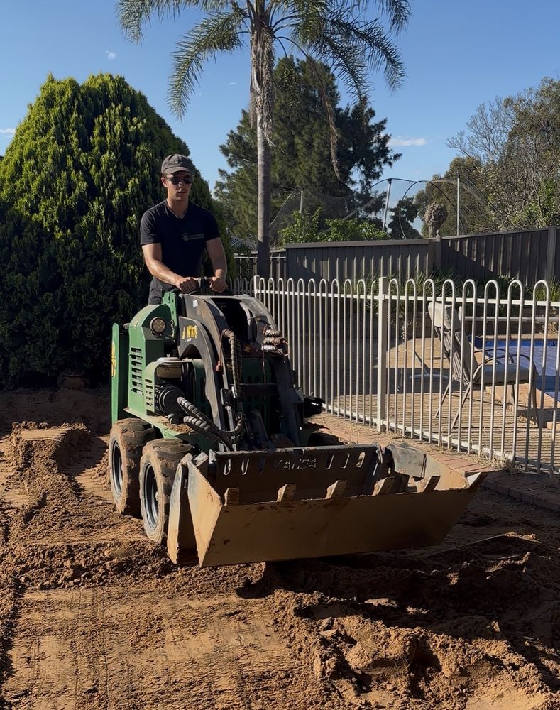 Damon Baggaley, owner of SA Gardens & Maintenance, levelling a yard with a Kanga loader